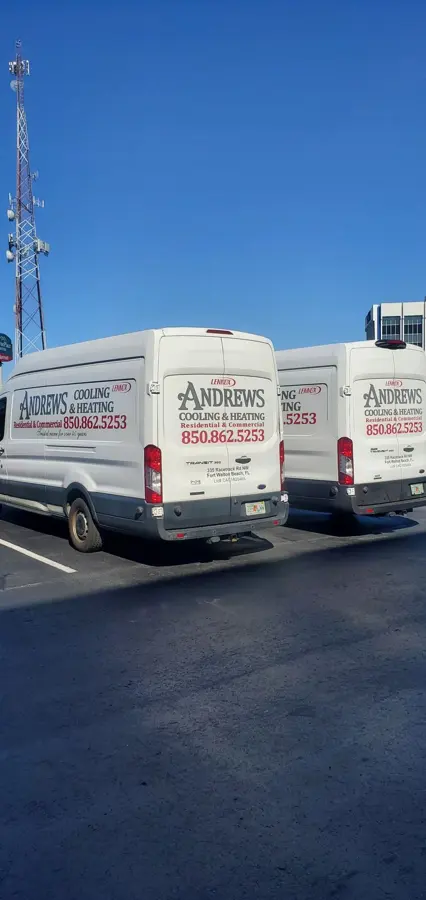 Two Andrews Cooling & Heating vans parked in a lot